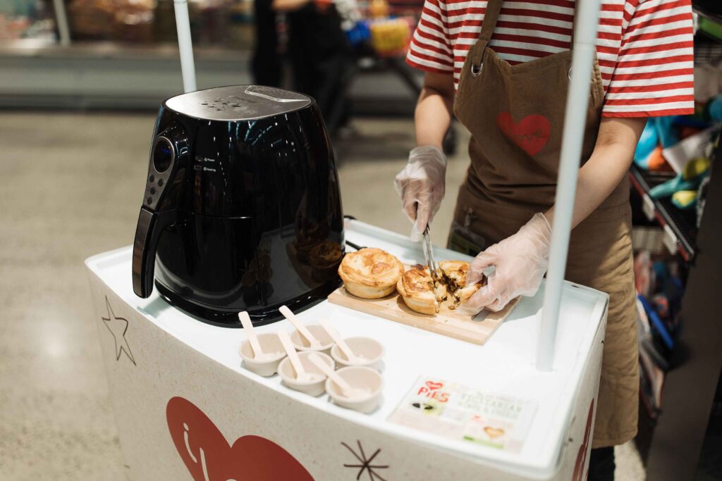 Food samples being prepared for shoppers to entice shoppers to buy from the brand.