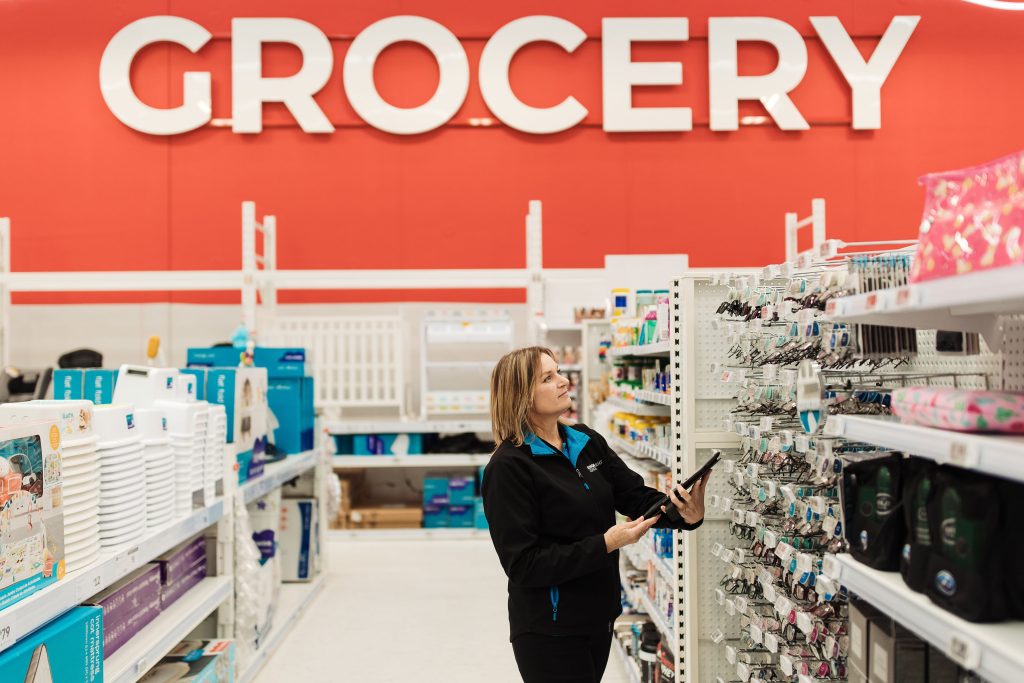 Retail Merchandiser checking stock levels shelves in-store.